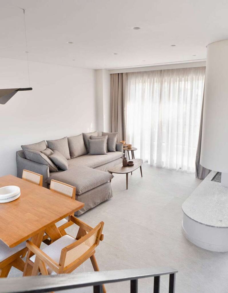 Comfortable lounge area with a large sofa and stylish coffee table in the heart of Kepos Villas