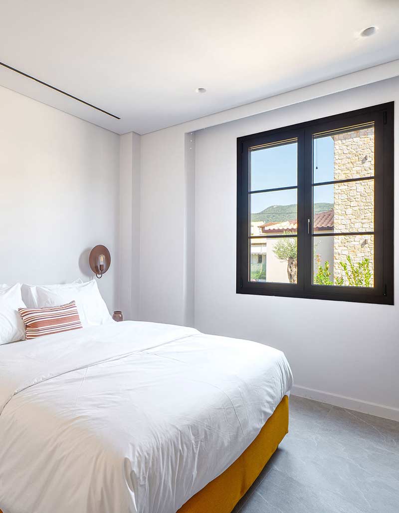 Cozy guest bedroom with high-quality mattresses, perfect for families at Kepos Villas