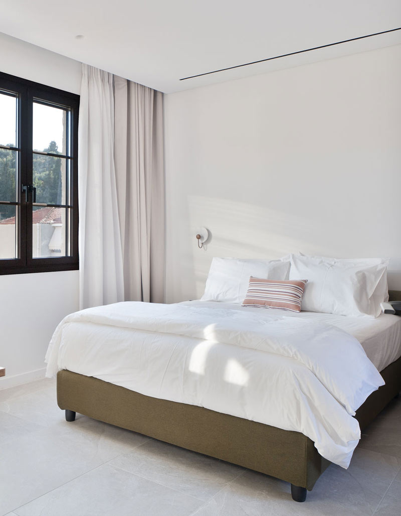 Spacious master bedroom at Kepos Villas with a king-size bed, premium linens, and elegant minimalist decor.